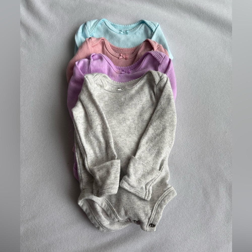 Carter’s Set of Four Baby Onesies in Pastel Colors
